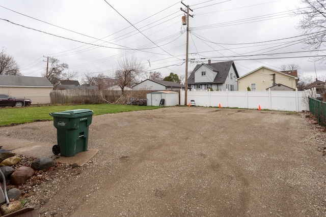 880 White Ave, Lincoln Park, MI 48146 - view of yard featuring an outbuilding, a fenced backyard, and a storage unit