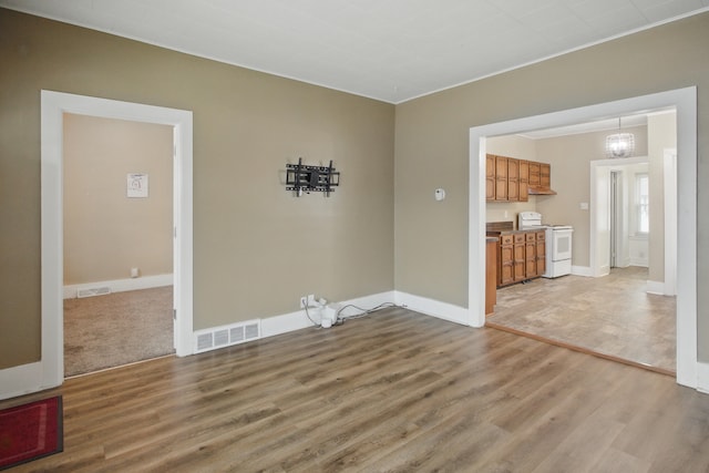 880 White Ave, Lincoln Park, MI 48146 - unfurnished dining area with light wood-style floors, baseboards, and visible vents