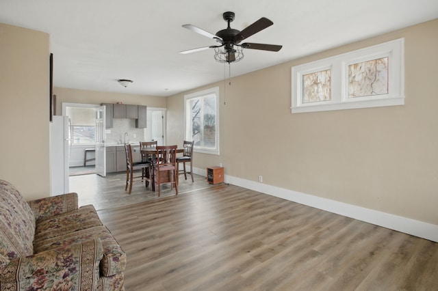 880 White Ave, Lincoln Park, MI 48146 - dining space with baseboards, a ceiling fan, plenty of natural light, and wood finished floors