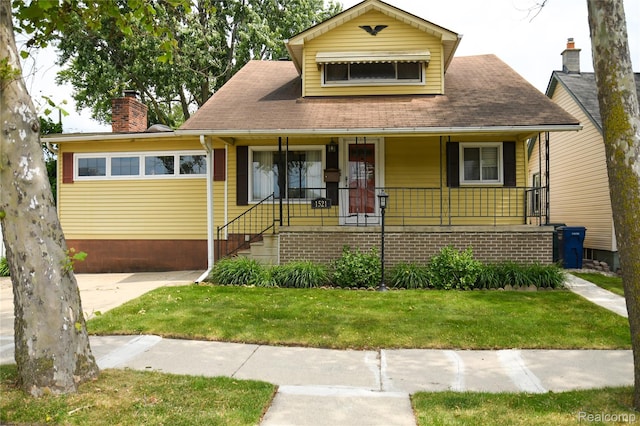 1521 Ferris Ave, Lincoln Park, MI 48146 - bungalow-style home with covered porch, a front lawn, and a chimney