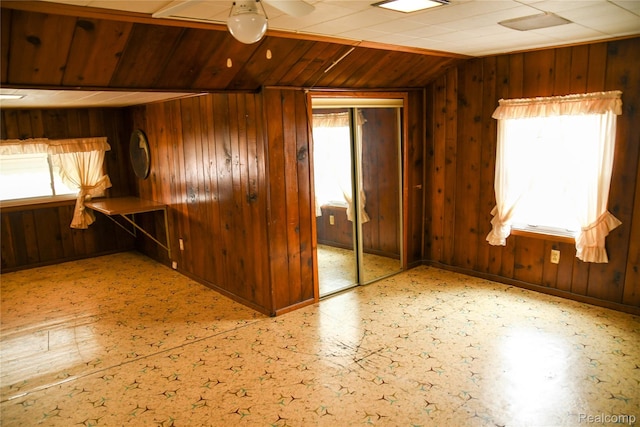1521 Ferris Ave, Lincoln Park, MI 48146 - spare room with lofted ceiling, wooden walls, and ceiling fan