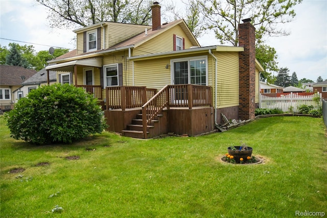1521 Ferris Ave, Lincoln Park, MI 48146 - back of property featuring a chimney, a fire pit, and a deck