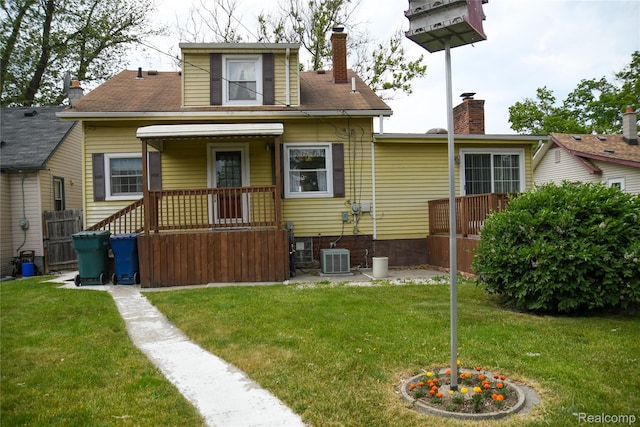 1521 Ferris Ave, Lincoln Park, MI 48146 - rear view of property with a lawn, a chimney, and central AC