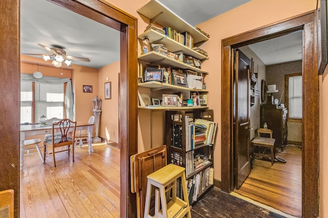 hallway with baseboards and wood finished floors