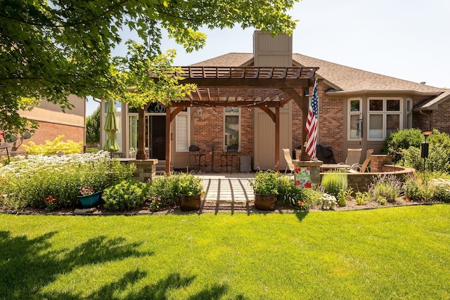 back of house with a lawn, a pergola, a patio area, and brick siding