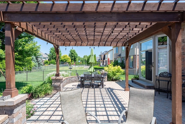 view of patio with fence, outdoor dining area, and a pergola