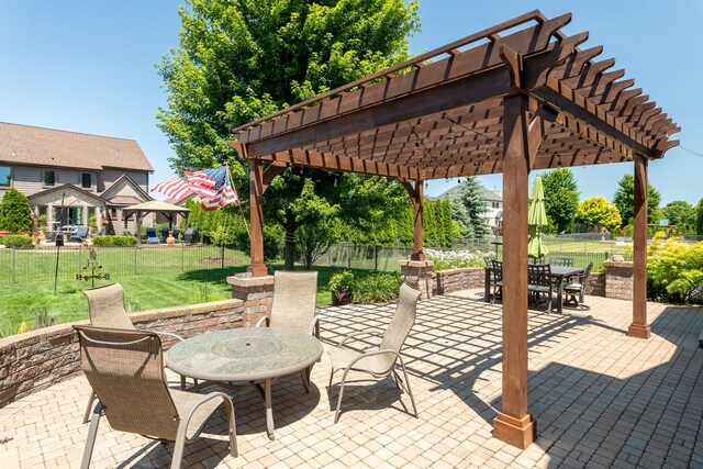 view of patio featuring a pergola, outdoor dining space, and a fenced backyard