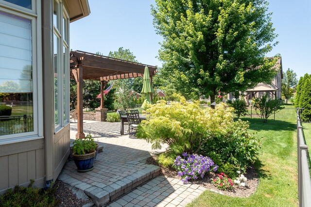 view of patio with a pergola, outdoor dining space, and fence