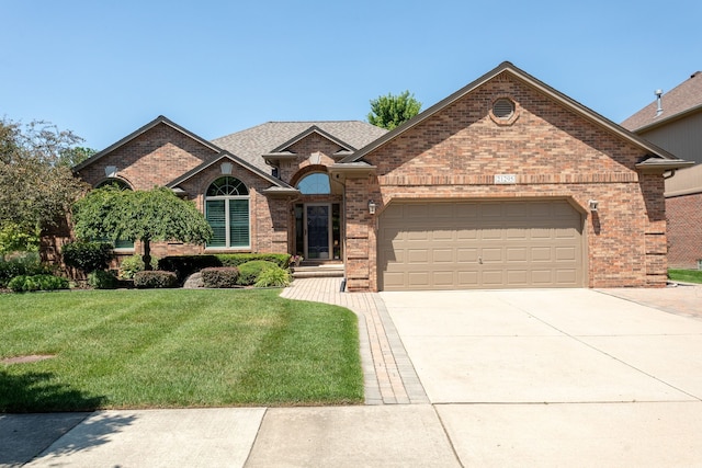 ranch-style house featuring brick siding, a front yard, concrete driveway, and an attached garage