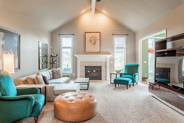 living area featuring a fireplace, ceiling fan, carpet flooring, and vaulted ceiling with beams