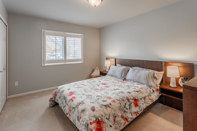 bedroom featuring carpet and baseboards