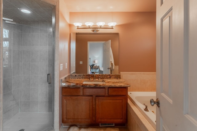 full bath featuring a garden tub, visible vents, a shower stall, and vanity