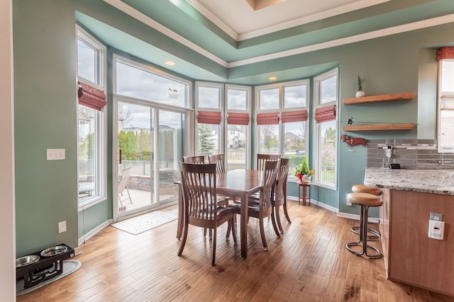 dining room with ornamental molding, recessed lighting, light wood-style floors, and baseboards