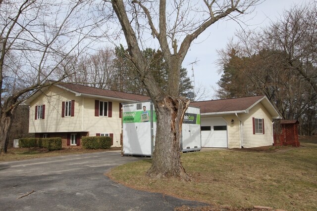 tri-level home with a front yard and driveway