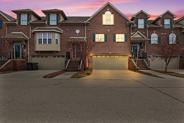 view of front facade featuring a garage, brick siding, and concrete driveway