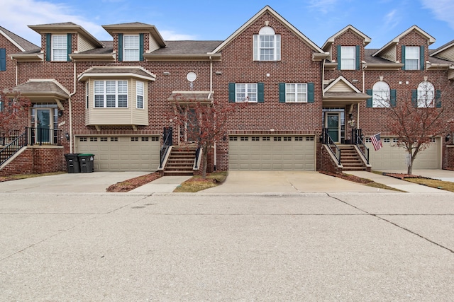 view of front of property with driveway, an attached garage, and brick siding