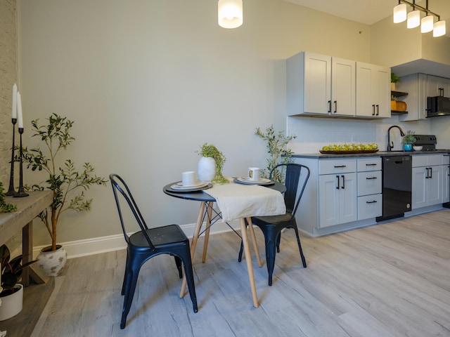 dining room with light wood finished floors and baseboards