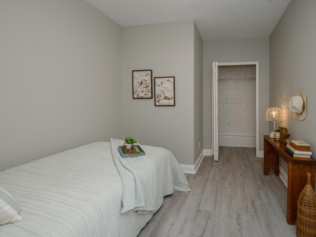 bedroom featuring baseboards and light wood-type flooring