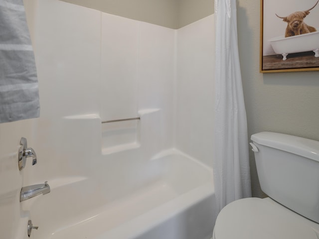 bathroom with toilet and shower / bath combination with curtain