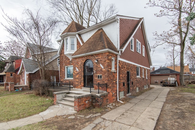 16917 Griggs St, Detroit, MI 48221 - english style home featuring brick siding, driveway, and a shingled roof