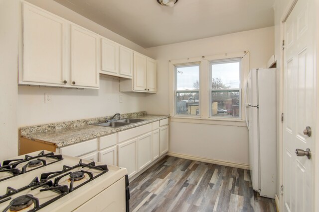 16917 Griggs St, Detroit, MI 48221 - kitchen featuring white appliances, baseboards, a sink, white cabinets, and wood finished floors