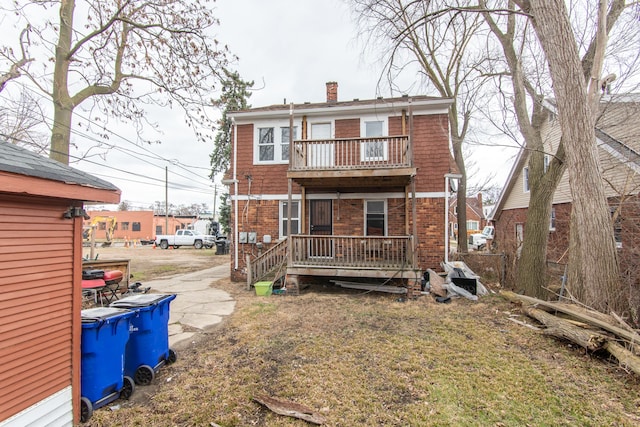 16917 Griggs St, Detroit, MI 48221 - view of front of house featuring a balcony, a chimney, and brick siding