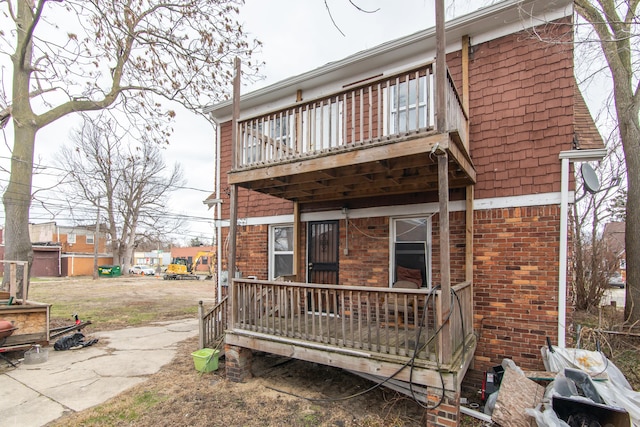 16917 Griggs St, Detroit, MI 48221 - back of house featuring brick siding, a porch, driveway, and a balcony