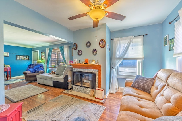 3803 Miller Rd, Kalamazoo, MI 49001 - living room featuring wood finished floors, ceiling fan, a glass covered fireplace, and baseboards