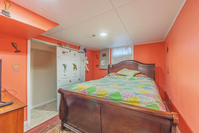 3803 Miller Rd, Kalamazoo, MI 49001 - bedroom featuring baseboards, light tile patterned flooring, and a closet