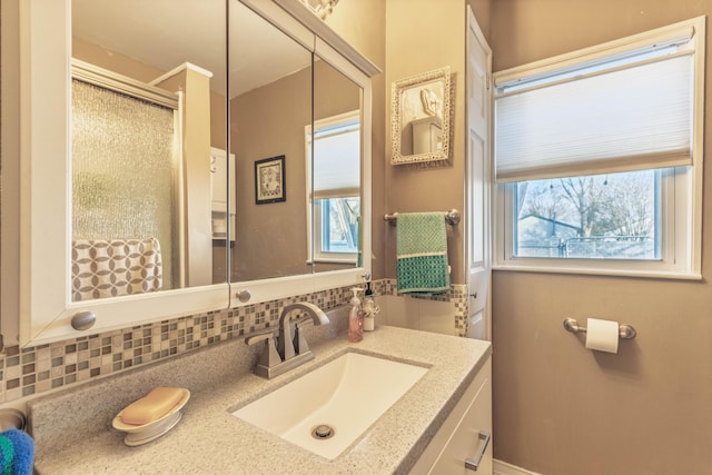 3803 Miller Rd, Kalamazoo, MI 49001 - full bath featuring tasteful backsplash, vanity, plenty of natural light, and a shower with door
