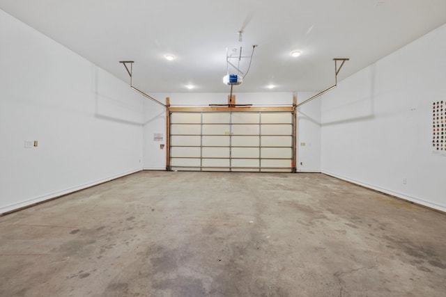 garage with baseboards and a garage door opener