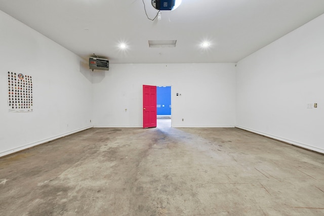 garage featuring baseboards, heating unit, recessed lighting, and a garage door opener