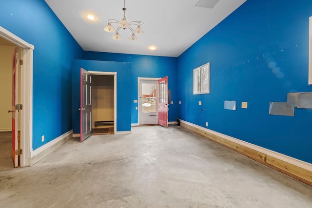 unfurnished bedroom with baseboards, concrete floors, a notable chandelier, and baseboard heating