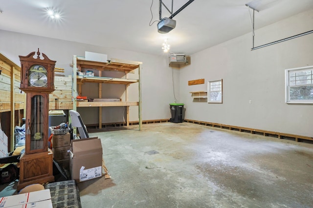 garage featuring a wall mounted AC and a garage door opener
