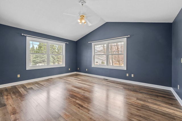 spare room featuring wood finished floors, baseboards, vaulted ceiling, and ceiling fan