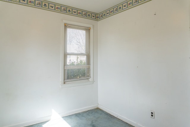 unfurnished room featuring baseboards and carpet flooring