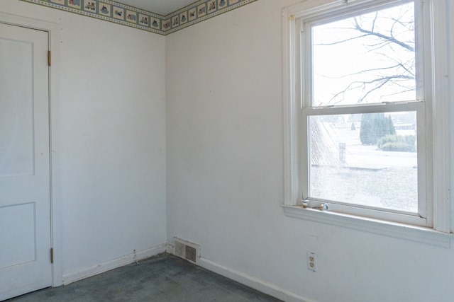spare room with baseboards and visible vents