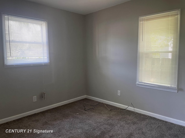 carpeted spare room with baseboards