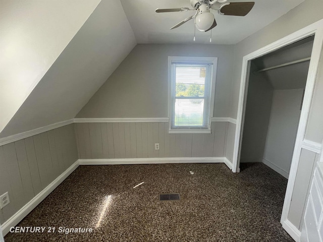 additional living space with lofted ceiling, ceiling fan, and visible vents