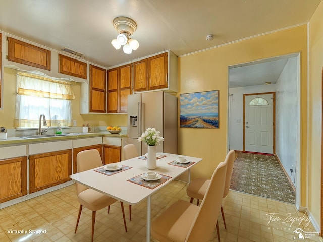 20212 Northline Rd, Taylor, MI 48180 - kitchen with fridge with ice dispenser, light flooring, a sink, light countertops, and brown cabinetry