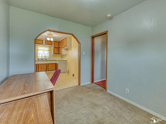 20212 Northline Rd, Taylor, MI 48180 - kitchen featuring arched walkways, a sink, light countertops, light colored carpet, and baseboards
