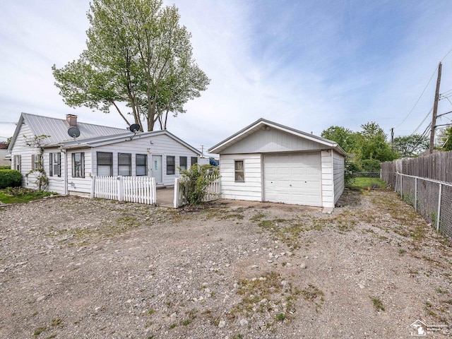 20212 Northline Rd, Taylor, MI 48180 - rear view of house with a detached garage, an outbuilding, and metal roof