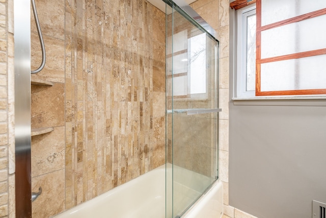 full bathroom with shower / bath combination with glass door