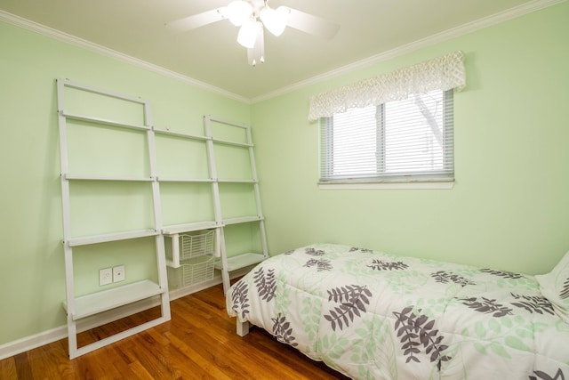 bedroom featuring wood finished floors, ceiling fan, and ornamental molding