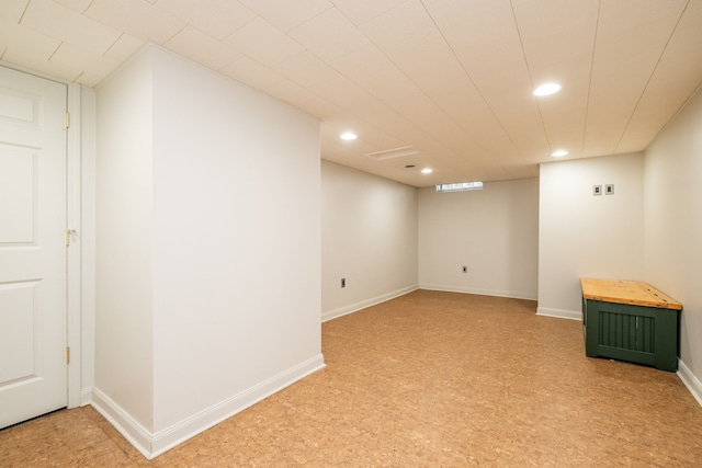 finished below grade area featuring baseboards and recessed lighting