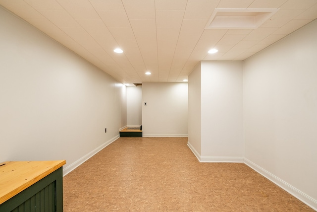 finished basement featuring baseboards and recessed lighting