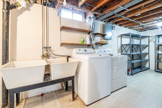 laundry room with separate washer and dryer, a sink, tile patterned floors, and laundry area