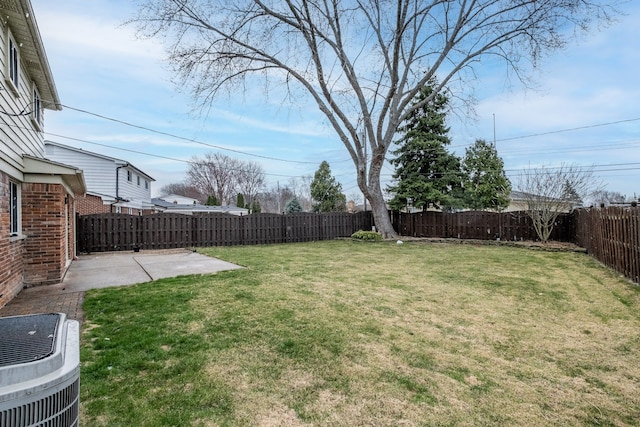 view of yard featuring a fenced backyard, central AC, and a patio area