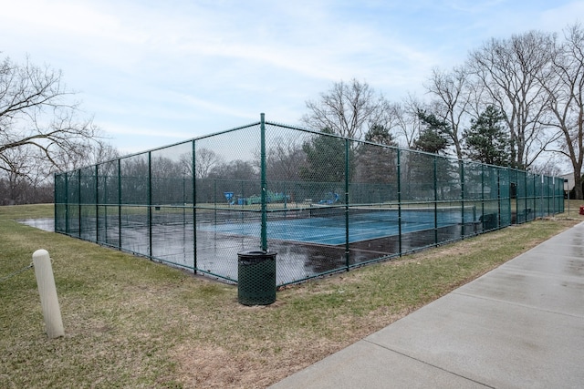 view of tennis court featuring fence