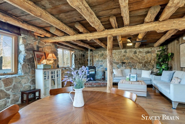 2620 36th St, Allegan, MI 49010 - unfurnished dining area featuring beamed ceiling, a wood stove, and wooden ceiling